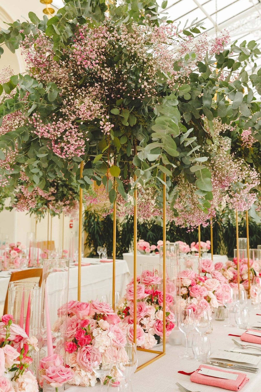 Elegant wedding venue decorated with pink flowers and green foliage